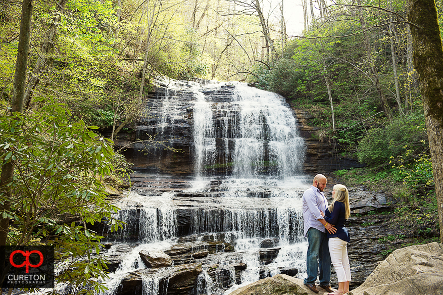 A couple standing in front of Pearson's Falls in Saluda,NC.