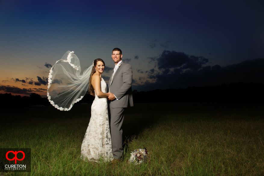 A couple in a field at San Souci Farms after their wedding.