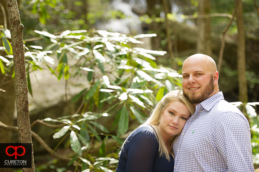 A girl leans of her fiancee during their Pearson's Falls engagement session.