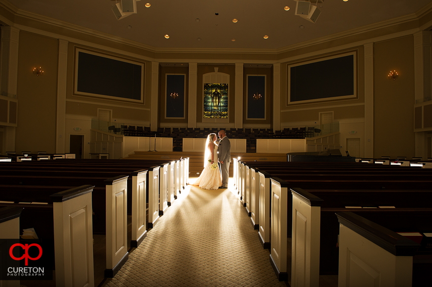 Married couple standing between the pews after the ceremony at Berea First Baptist Church.