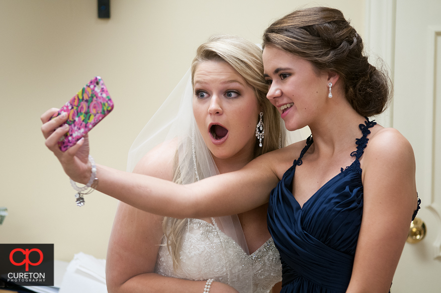 Bride taking selfies.