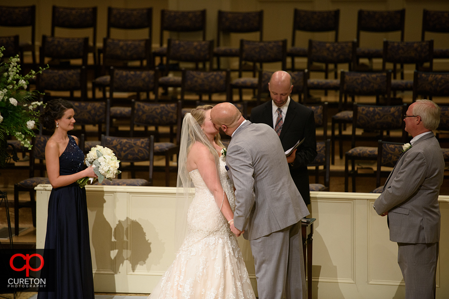 Bride and groom first kiss.