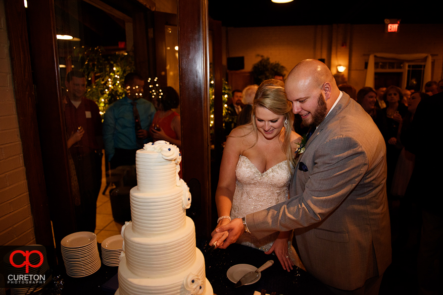 Bride and groom cut cake.
