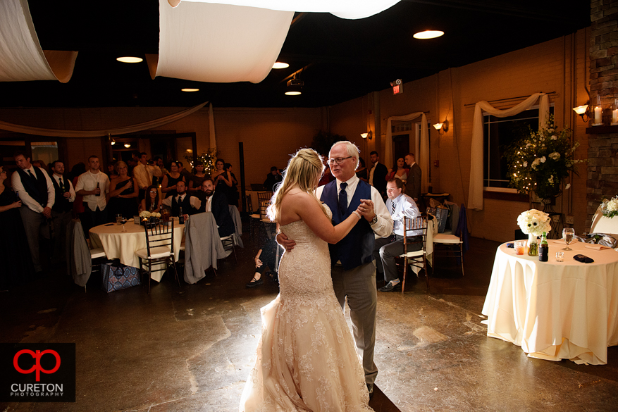 Bride dancing with er father at the reception.