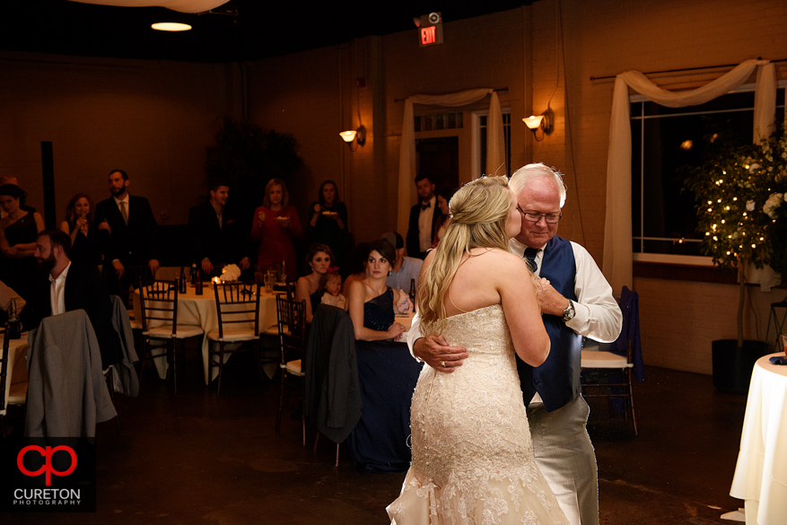 Bride dancing with er father at the reception.