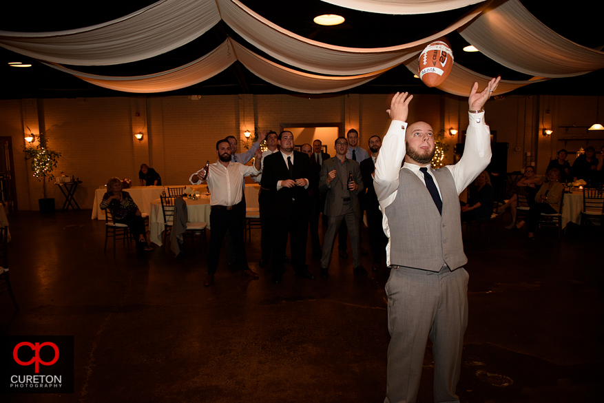 Groom tossing the garter.