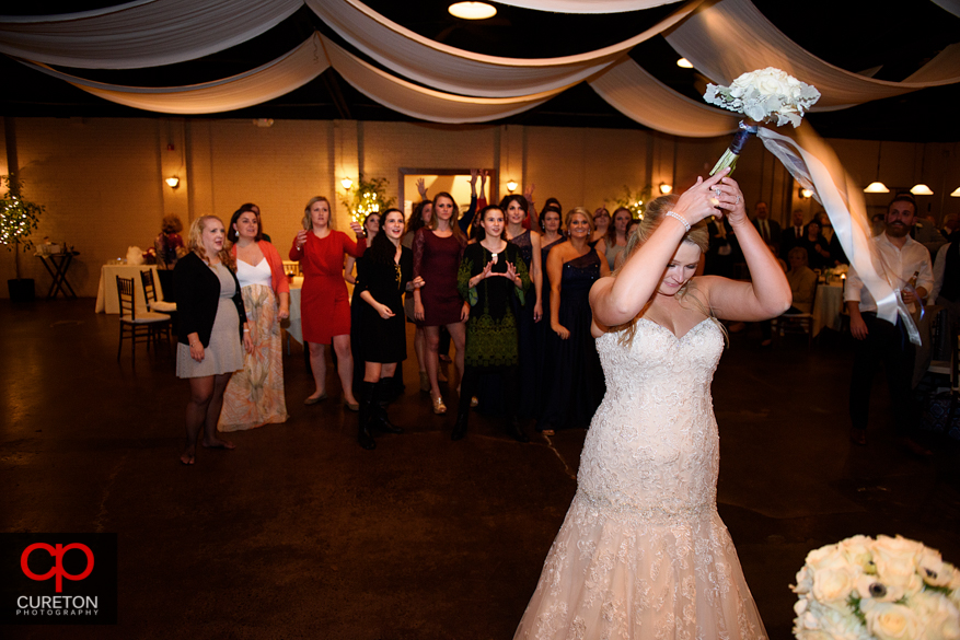 Bride tossing the bouquet .