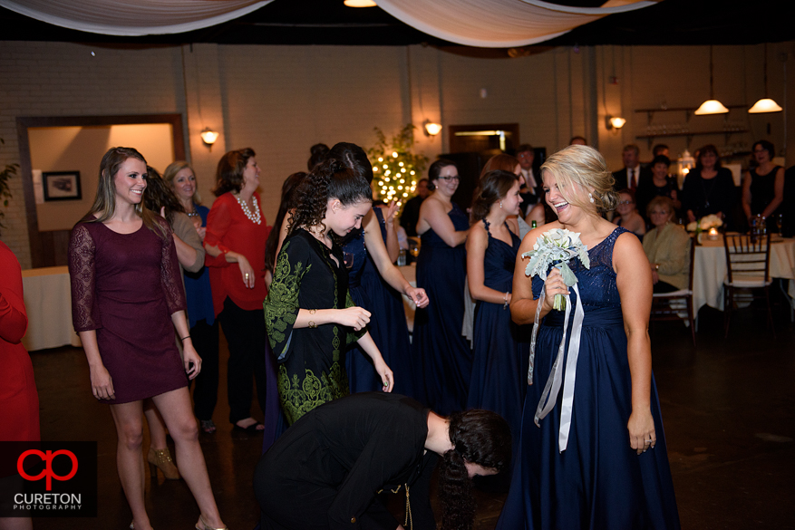 Bride tossing the bouquet .