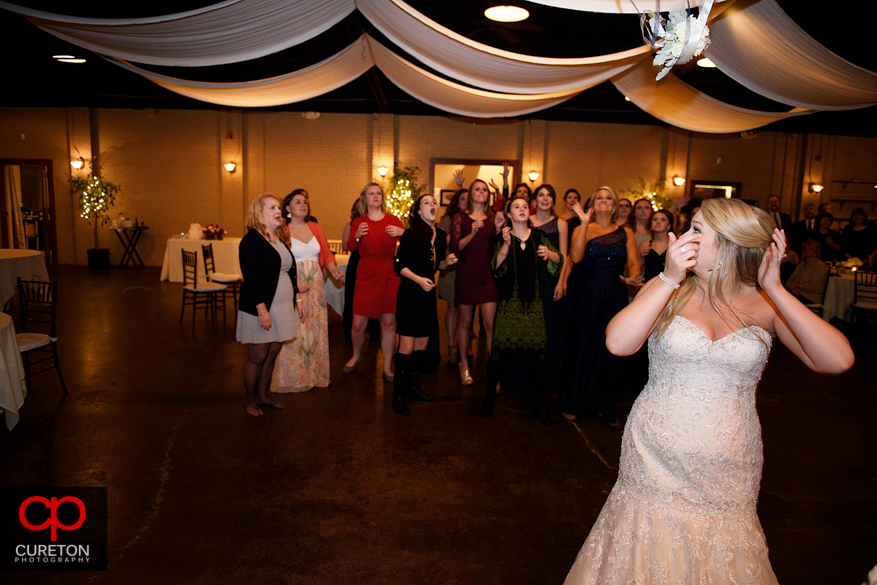 Bride tossing the bouquet .