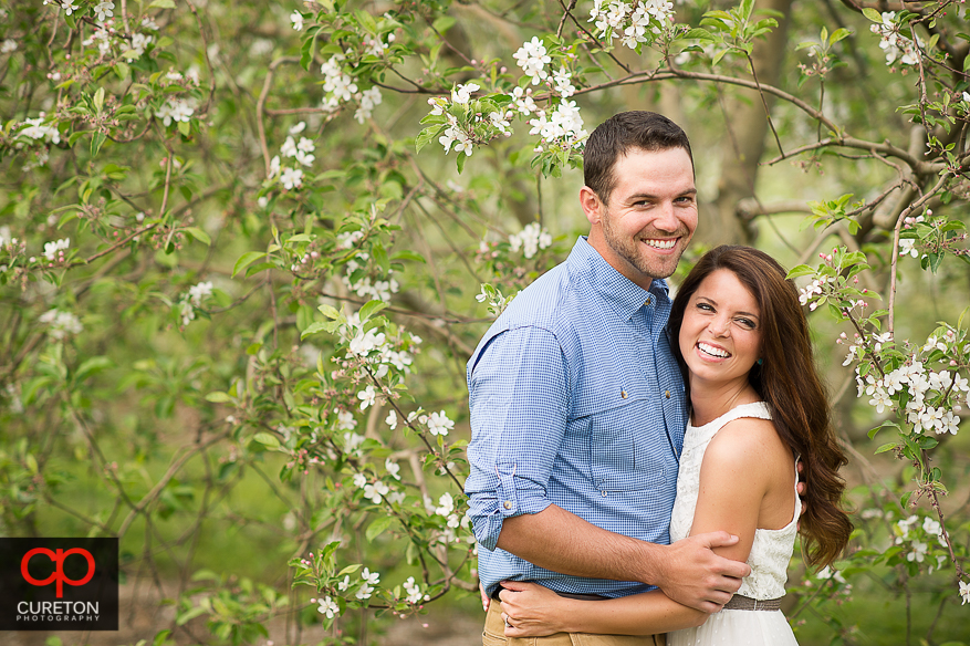 Engaged couple laughing during a photo session.