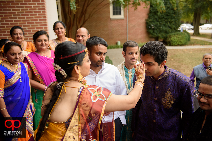 Family participates in a pre Indian wedding Vidhi ceremony at Presbyterian college.