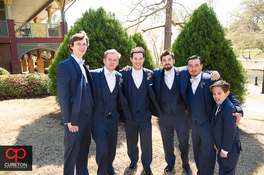 Groomsmen hanging out in the park.
