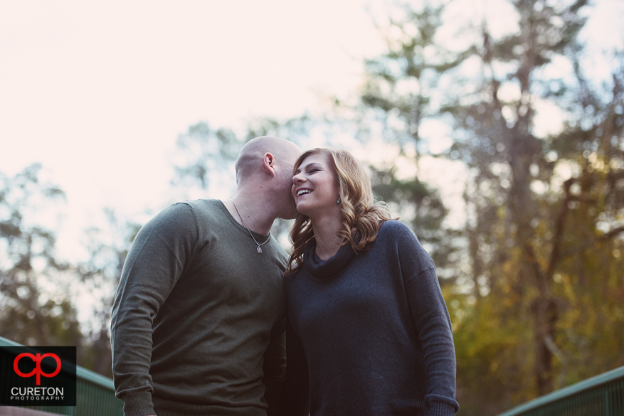 A future bride and groom at the rock quarry garden during an engagement session.