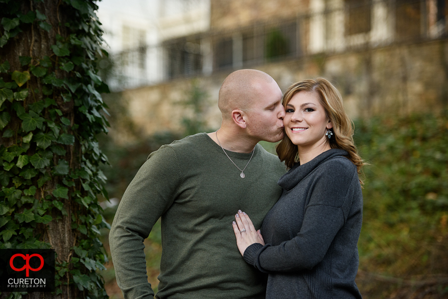 Fiancee kissing his bride to be.