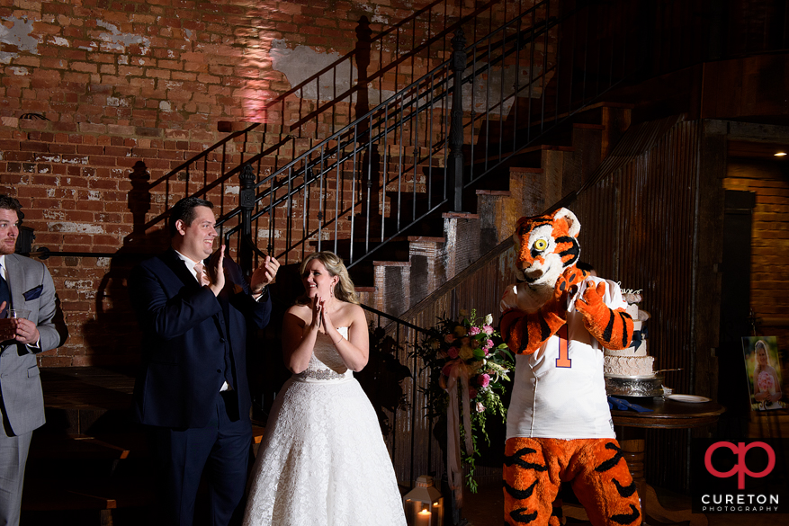 The bride and groom are joined by the Clemson Tiger for tiger rag at their wedding downtown.
