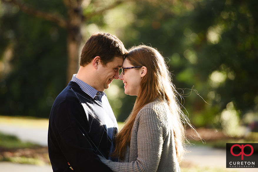 Couple looking at each other during a CLemson University engagement session.