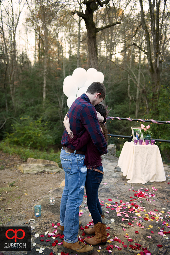 Man proposing to his fiancee at Campbell's covered bridge in Greer,SC.