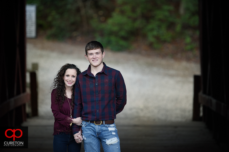 Newly engaged couple celebrating the proposal at Campbell's covered Bridge in Greer,SC.