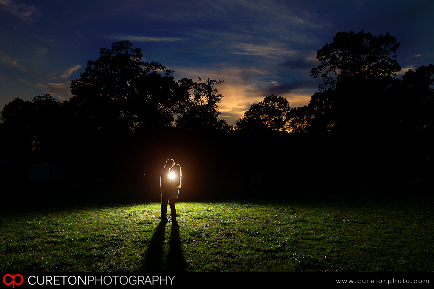 Backlit bride and groom at sunset.