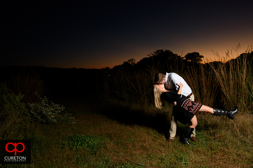 Engaged couple dancing at sunset.