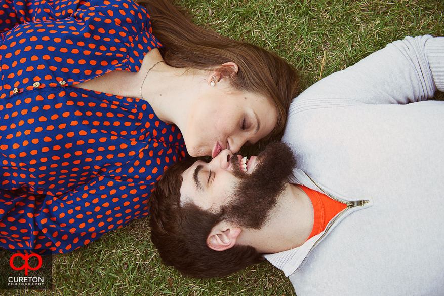 Couple kissing on the grass.