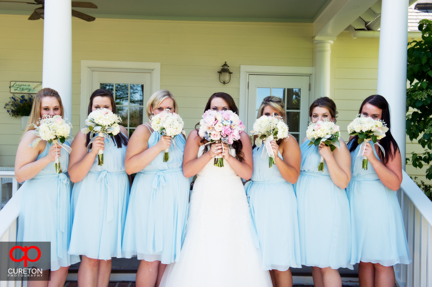 The bridesmaids on the steps of the house at Lenora's Legacy.
