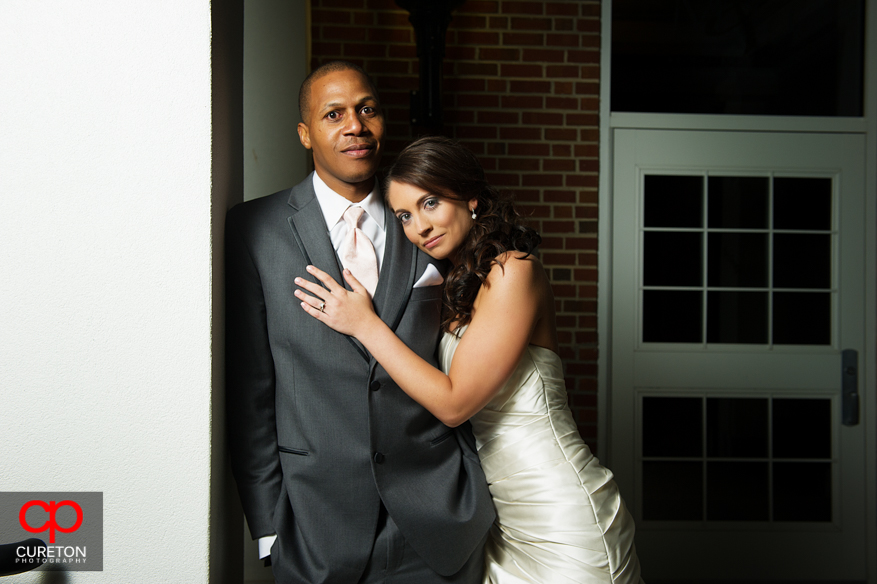 A bride and groom posing before their wedding reception at Upcountry History Museum.