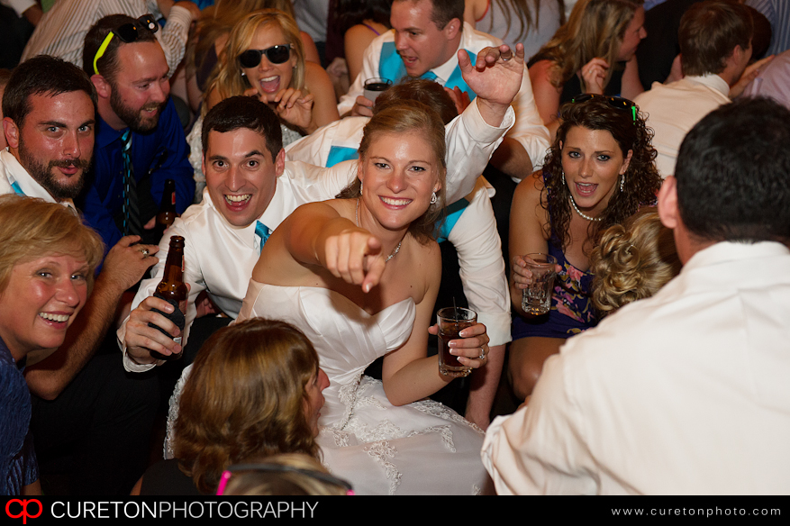 Bride and Groom in the middle of a crowd.