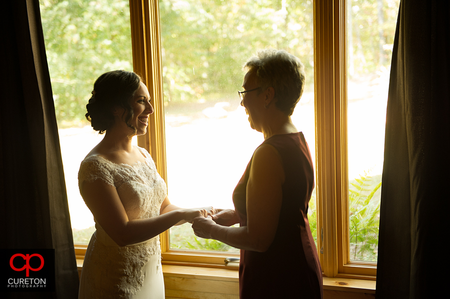 Bride and her mother helping her get ready.