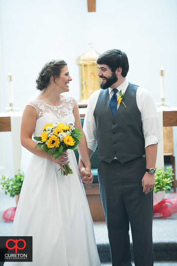 The bride and groom looking at each other as they are pronounced husband and wife.