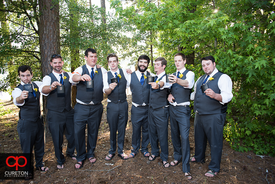 The groom and his groomsmen posing with their flasks.