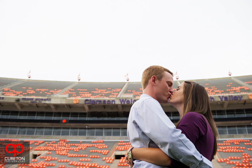 Couple kissing in the stadium at Clemson university.