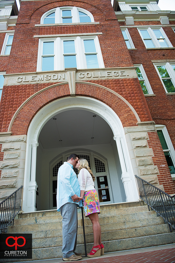 Engaged couple standin in front of Tillman Hall.