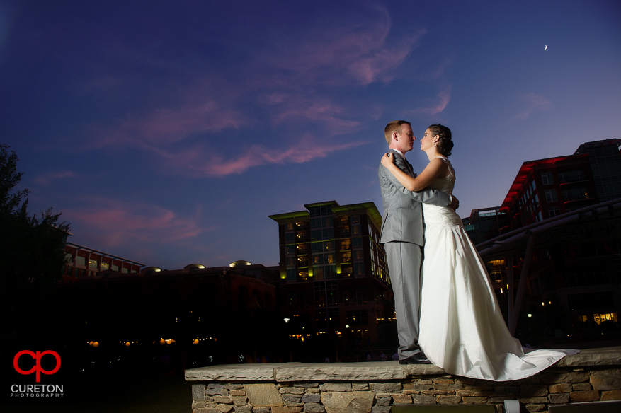 Couple dancing under the skyline of Greenville,SC at sunset.