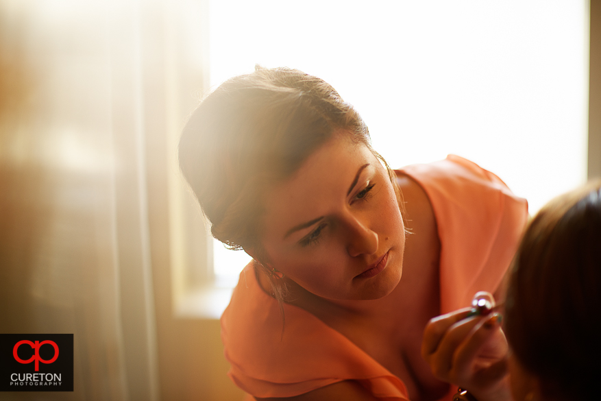 Makeup artist doing the brides makeup.