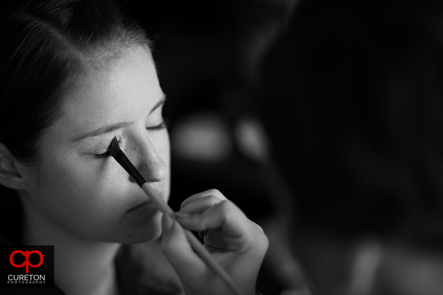 The bride has her eye makeup applied.