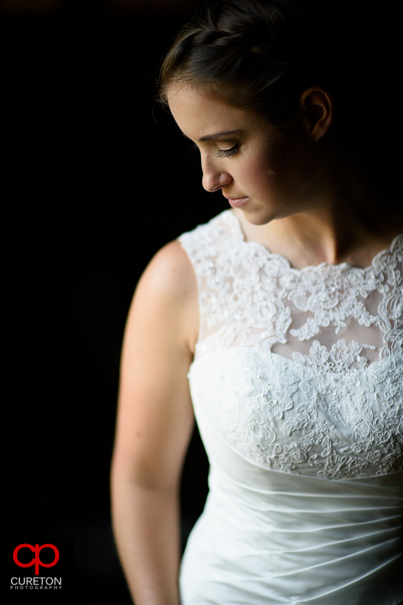 Beautiful bride standing in window light.