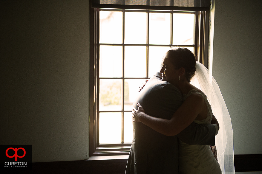 Bride and her father hugging during a first look.