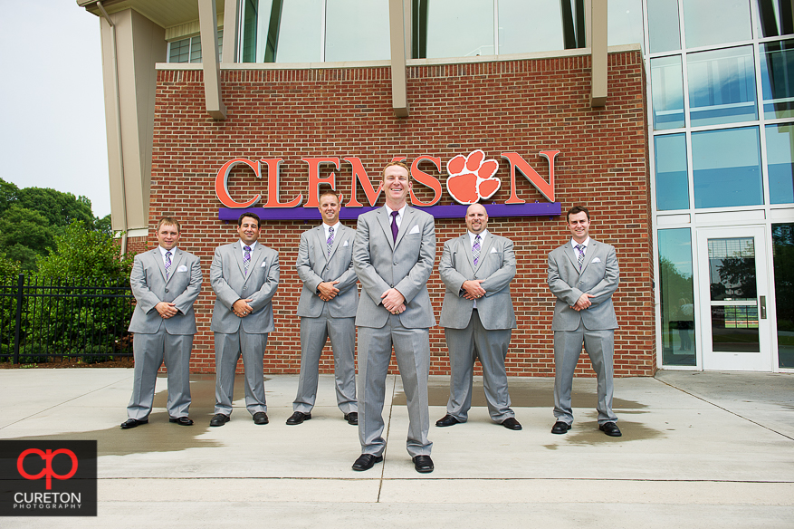 The groomsmen standing outside the Clemson indoor football complex.