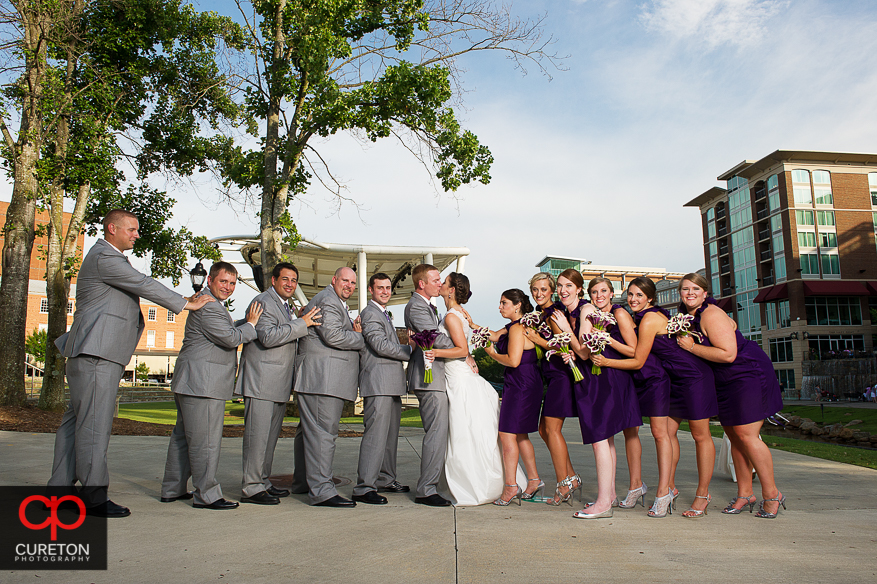 Bride and Groom pushed together by the wedding party.