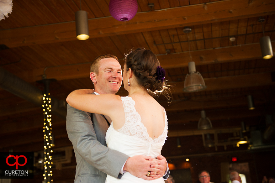 The bride and groom share a first dance.