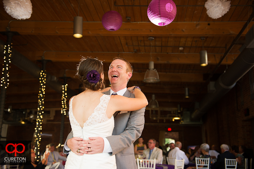 The bride and groom share a first dance.