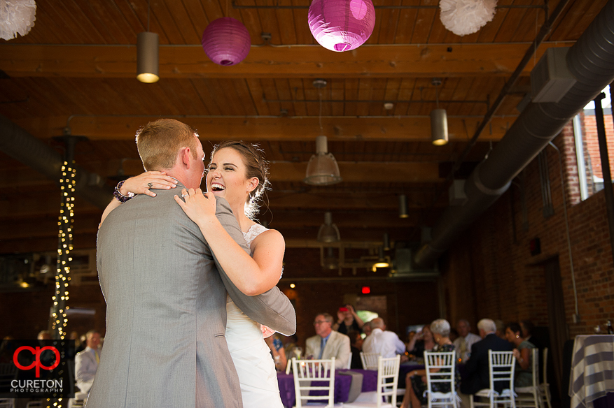 The bride and groom share a first dance.