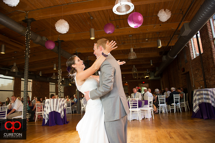 The bride and groom share a first dance.