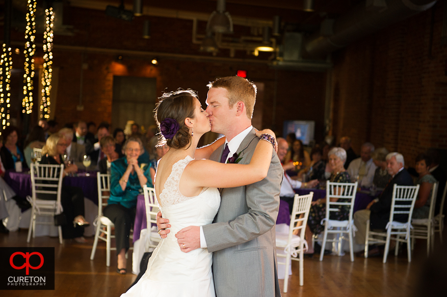 The bride and groom share a first dance.