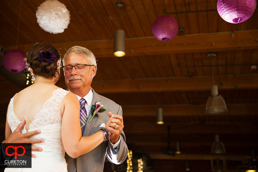 The bride dances with her father.