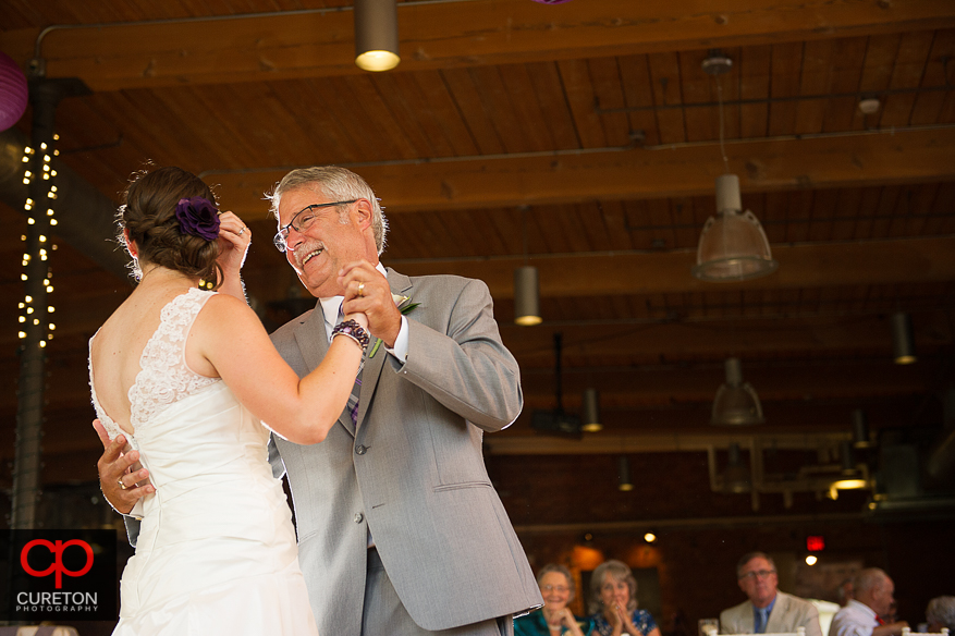 The bride dances with her father.