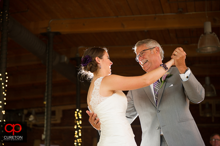 The bride dances with her father.