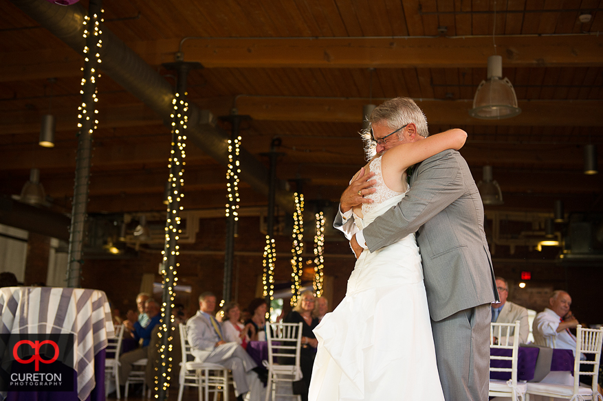 The bride dances with her father.