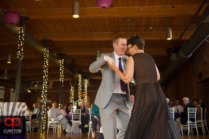 The groom dances with his mother.